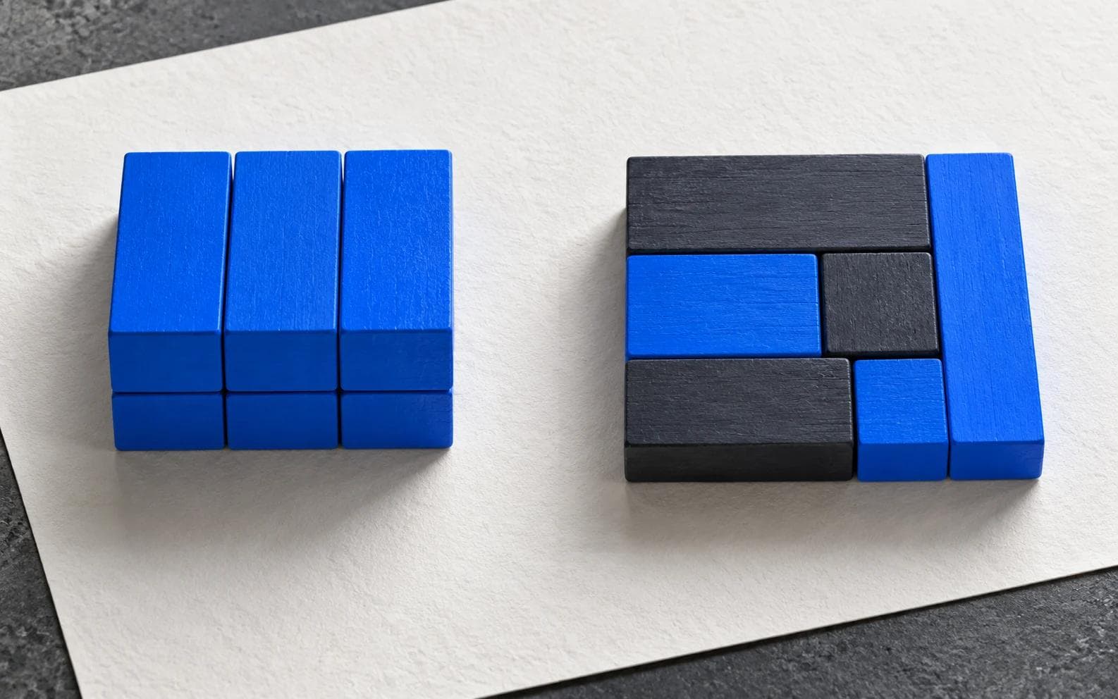 An organised blue modular block beside a tailored paper structure