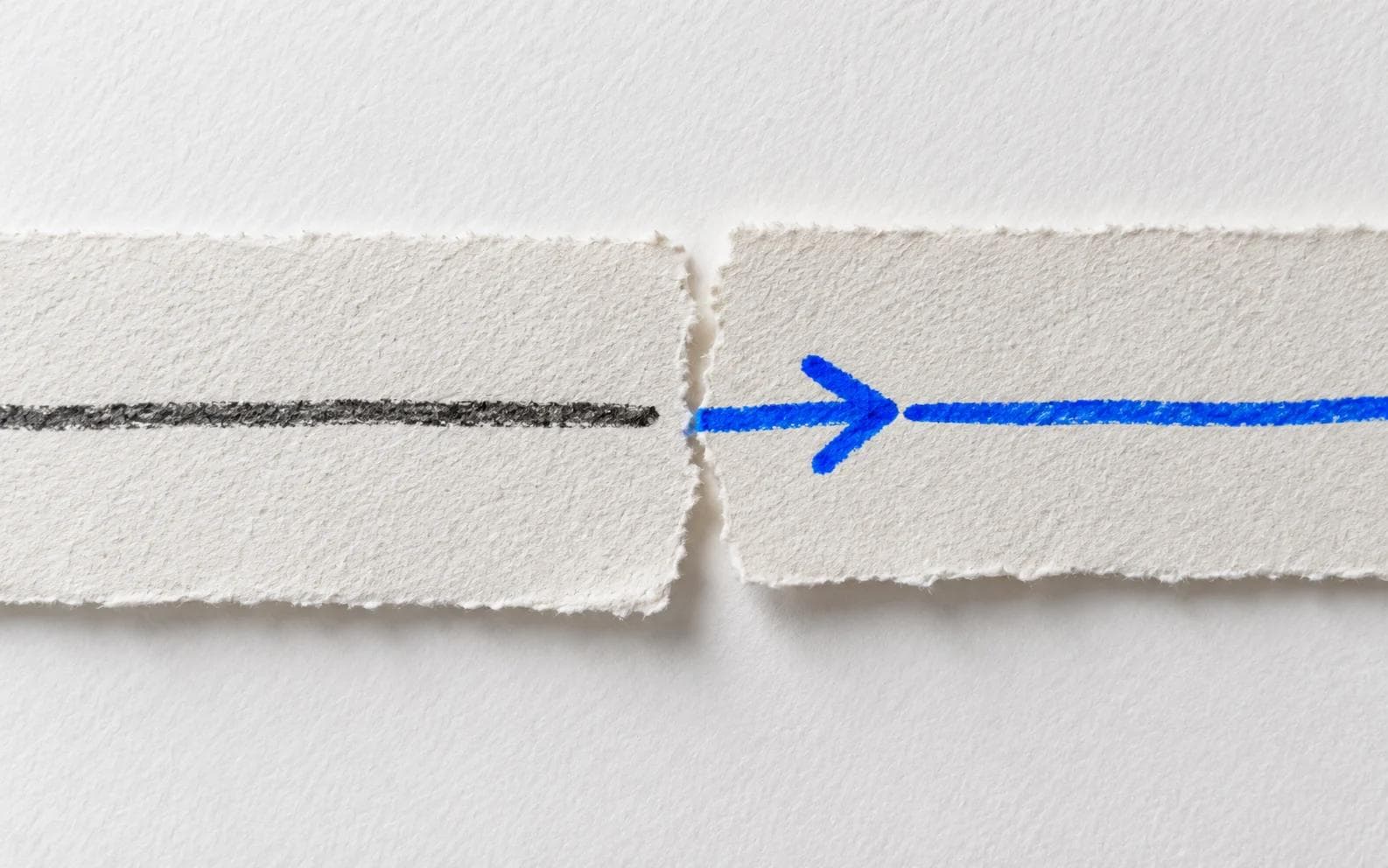 A blue arrow crossing the gap between two torn pieces of paper