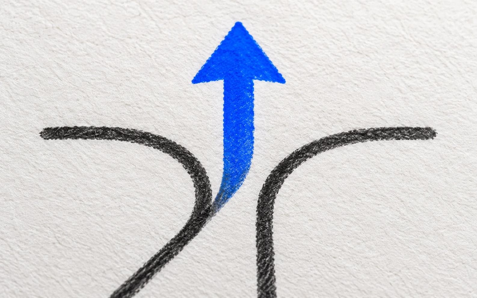 A blue arrow choosing between three charcoal paths on paper